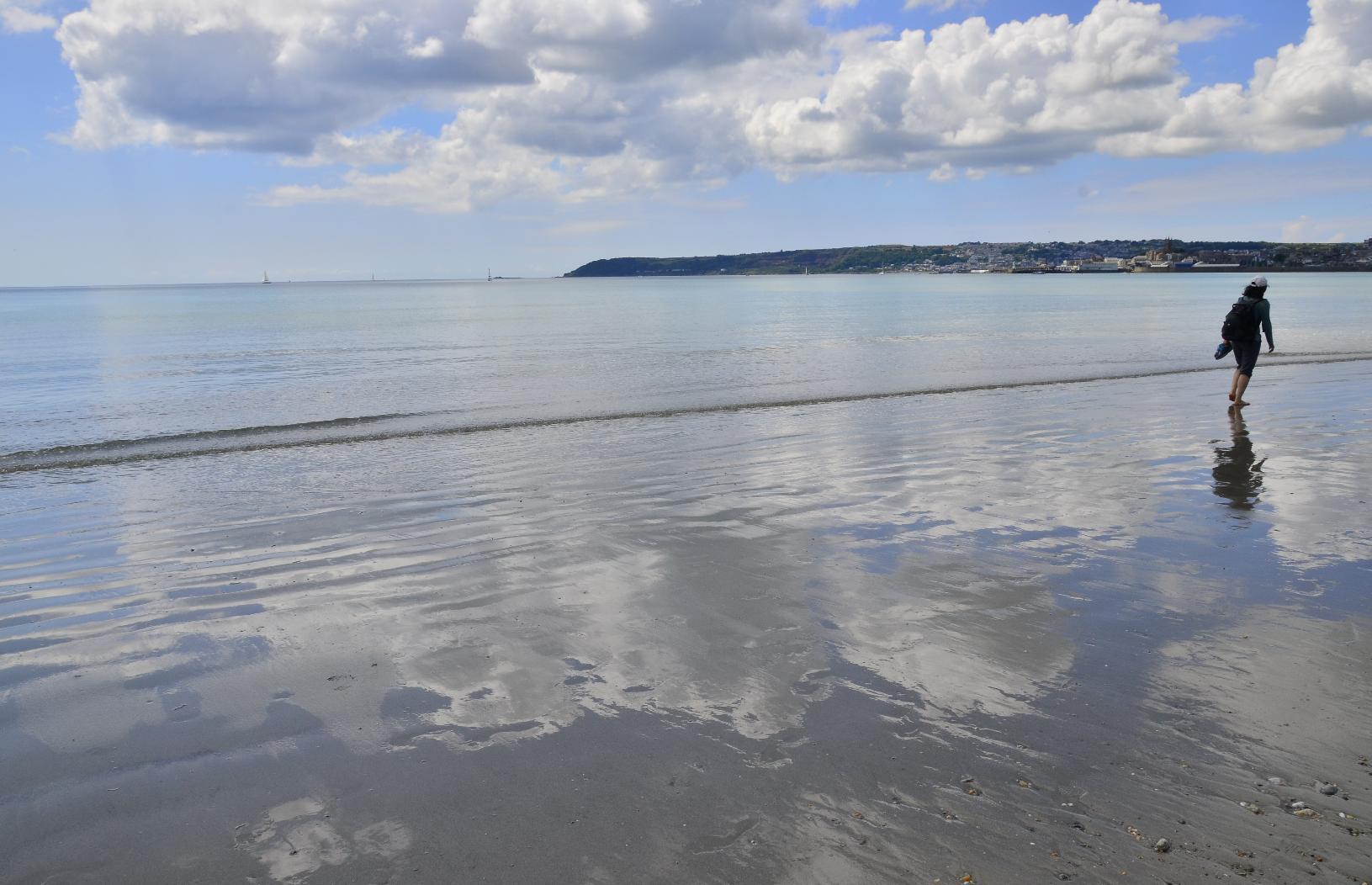 Shimmering reflection of the sky on the beach