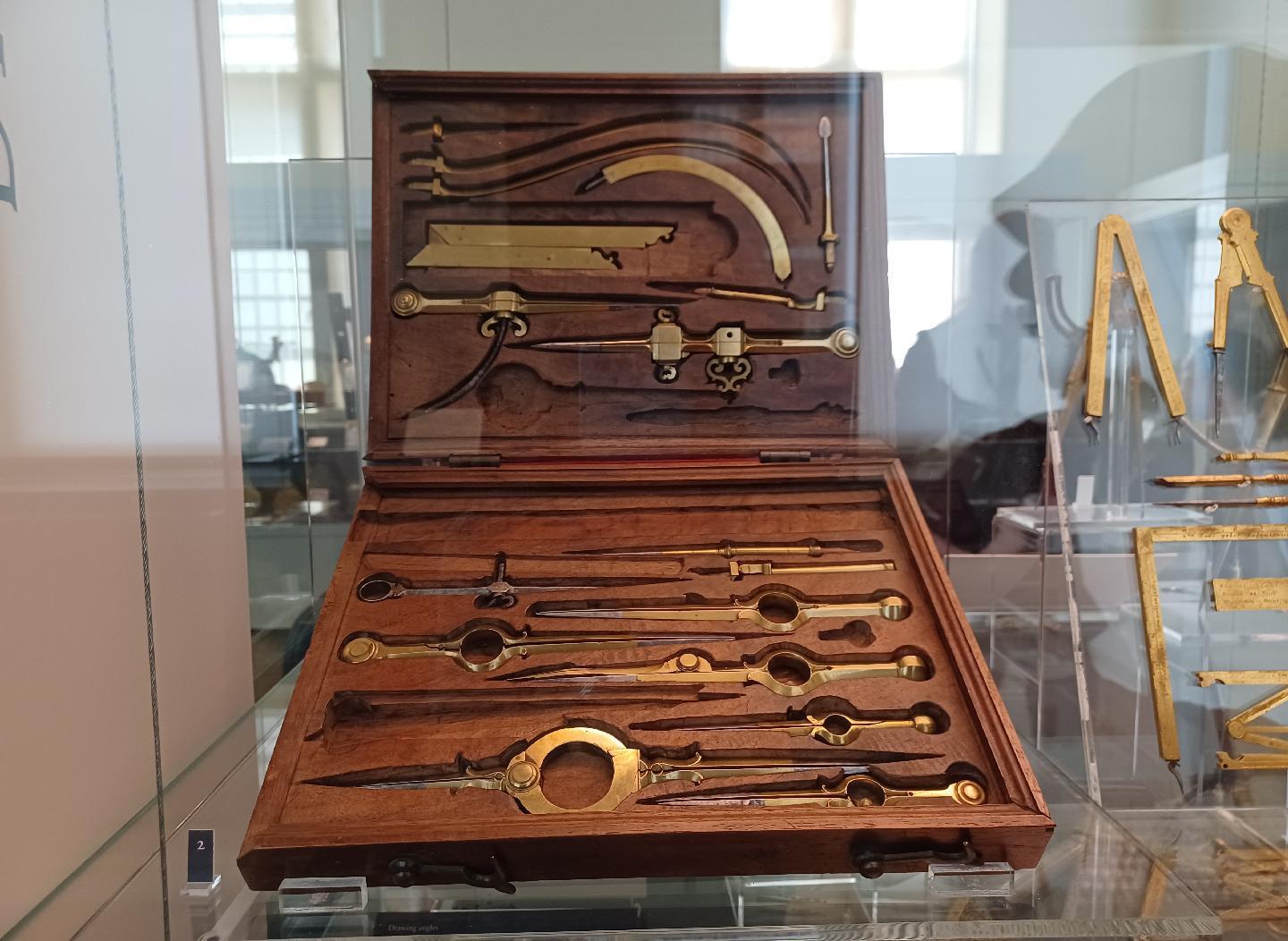 A box of brass drawing instruments