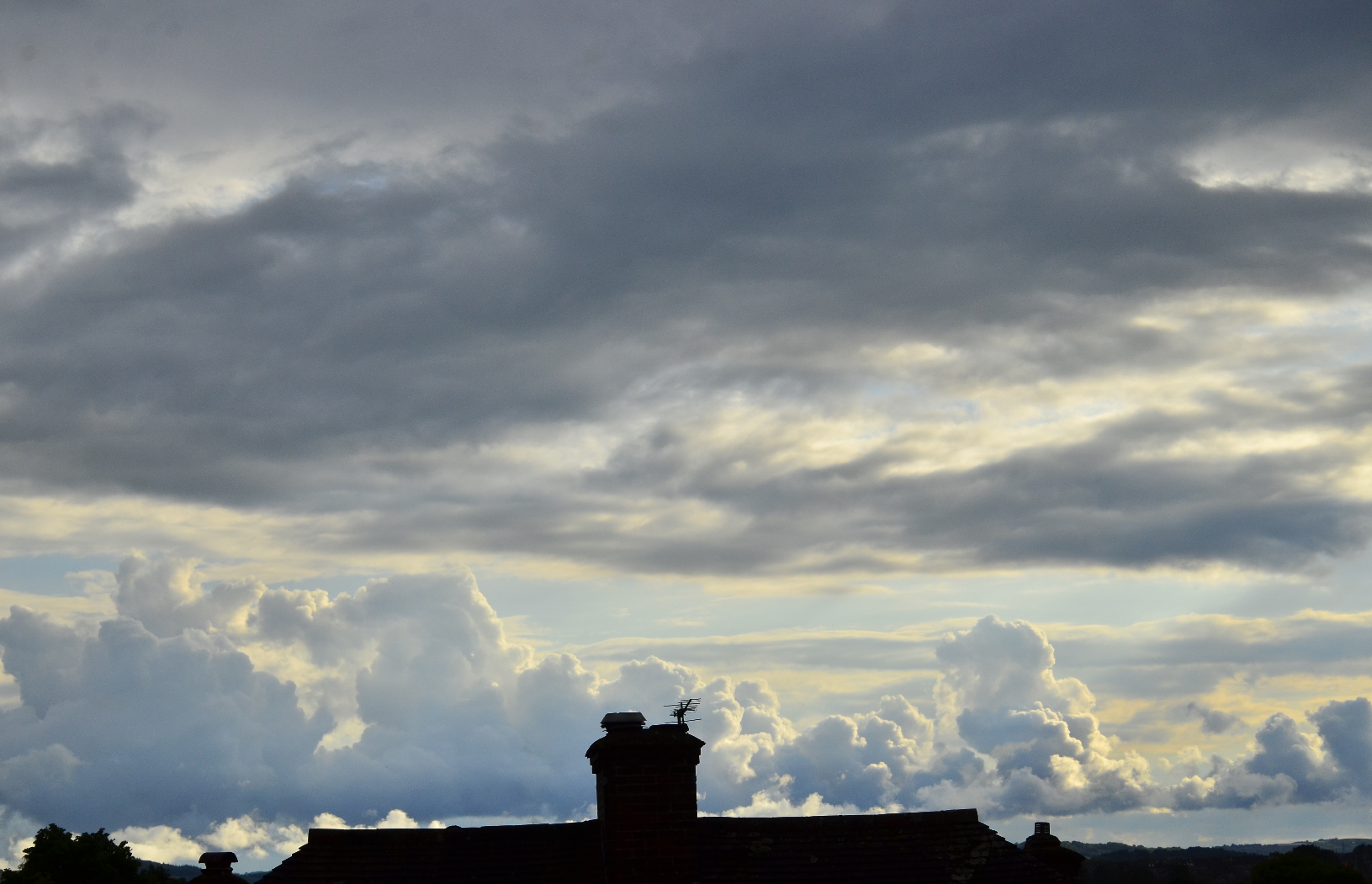 Clouds and roof silhouettes