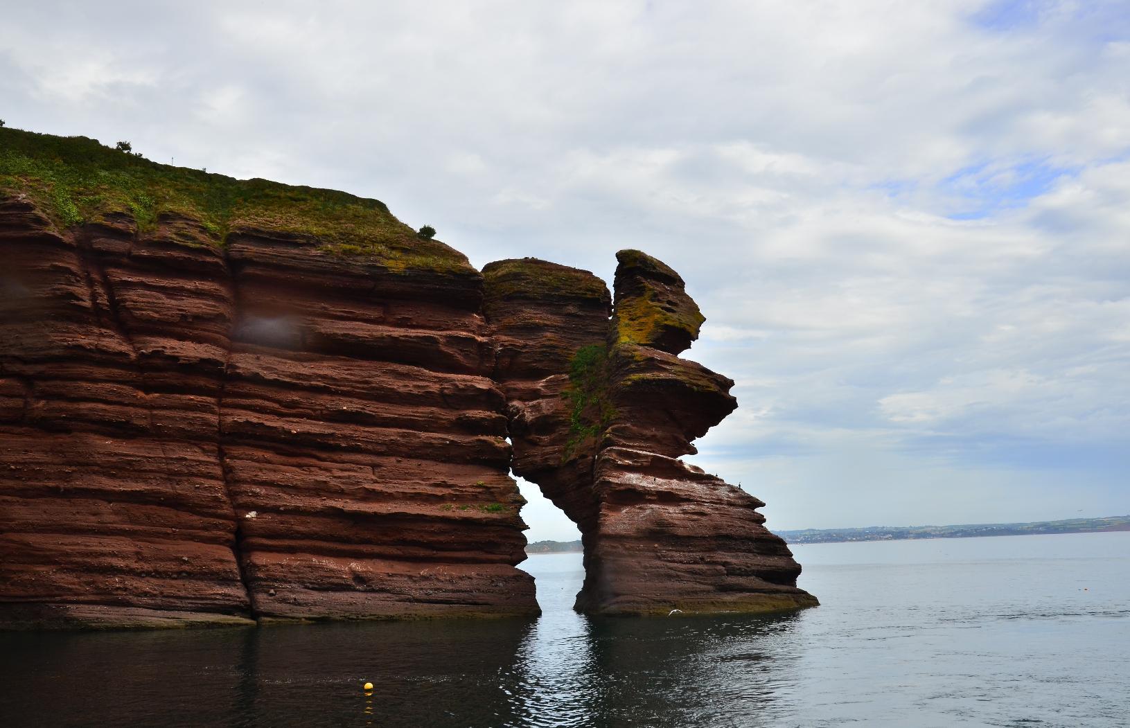 Eroded sandstone cliff with a large void